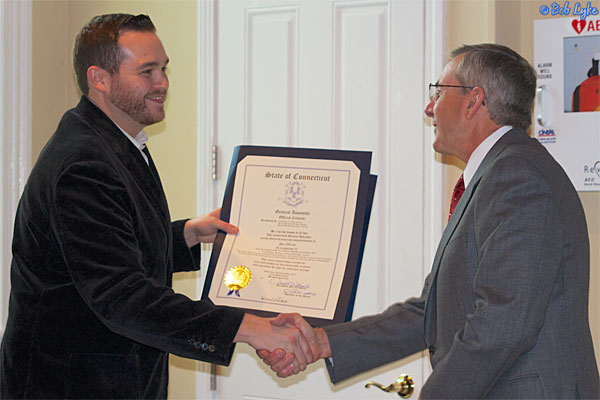 State Representative Chris Davis presenting a State Legislative Proclamation to Jim Nillson